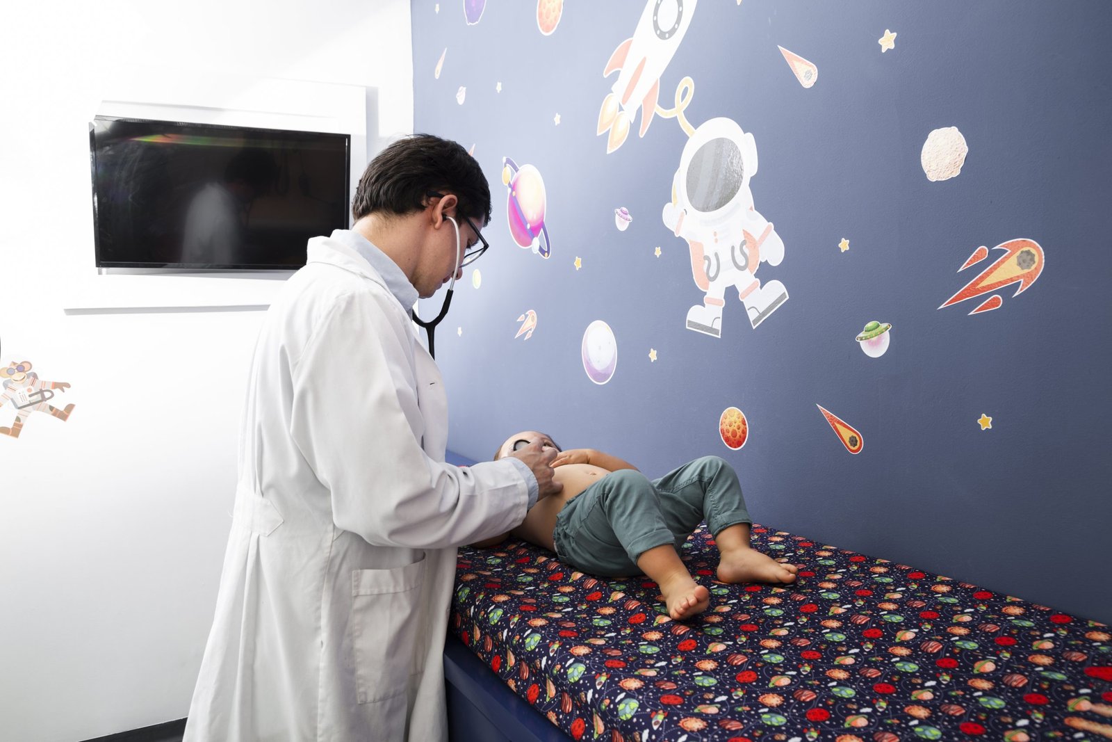 medium shot doctor checking baby boy scaled
